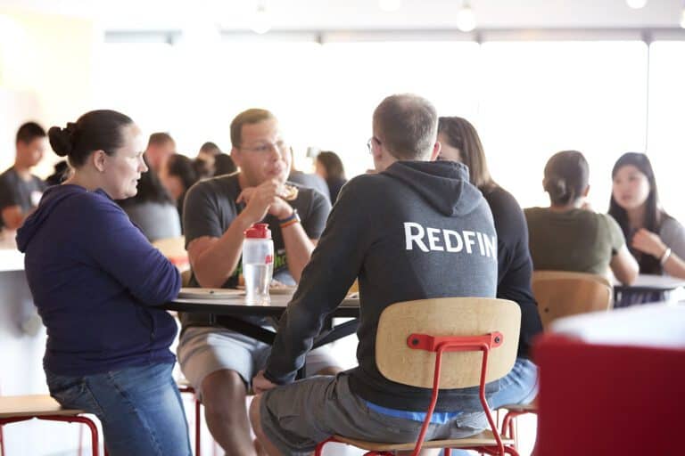 Redfin employees sit at a lunch table